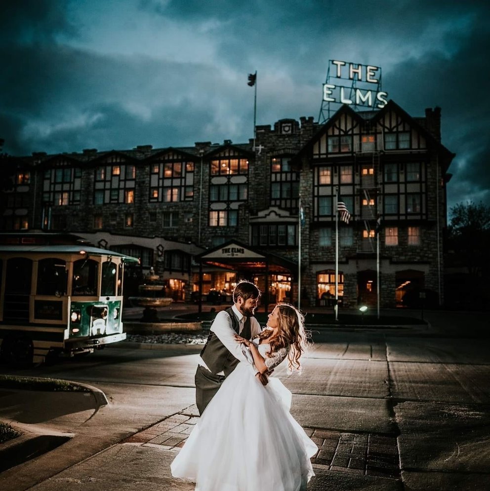 newlywed couple in front of the elms hotel and spa