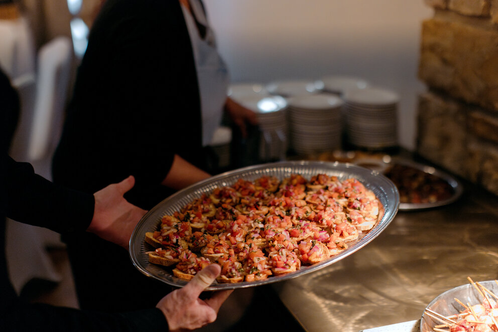 a person holding a tray of food